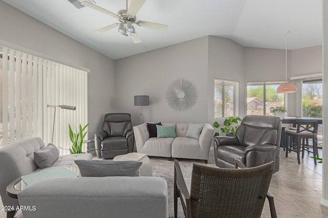 tiled living room featuring ceiling fan and vaulted ceiling