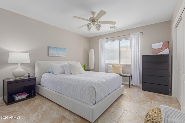 bedroom featuring ceiling fan and a closet