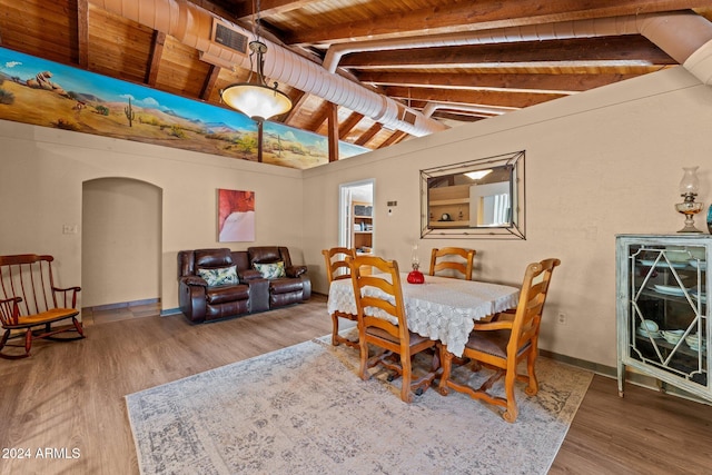 dining area with vaulted ceiling with beams, hardwood / wood-style floors, and wooden ceiling