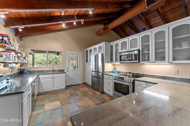 kitchen featuring appliances with stainless steel finishes, white cabinets, sink, and wooden ceiling