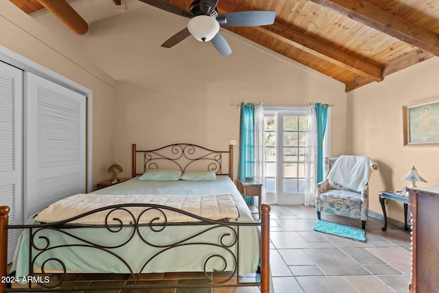 bedroom featuring a closet, wooden ceiling, lofted ceiling with beams, light tile patterned floors, and ceiling fan