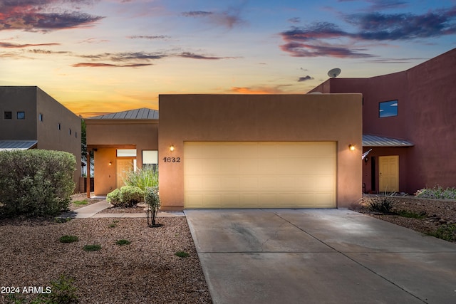 pueblo-style home with a garage