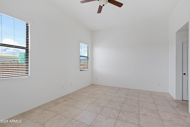 tiled spare room with ceiling fan and lofted ceiling