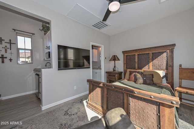 bedroom featuring visible vents, ceiling fan, connected bathroom, wood finished floors, and baseboards