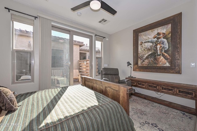 bedroom with a ceiling fan, access to outside, visible vents, and wood finished floors