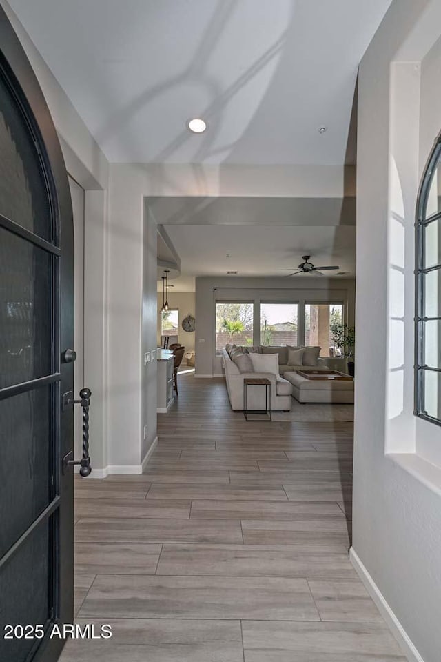 hall with wood tiled floor and baseboards