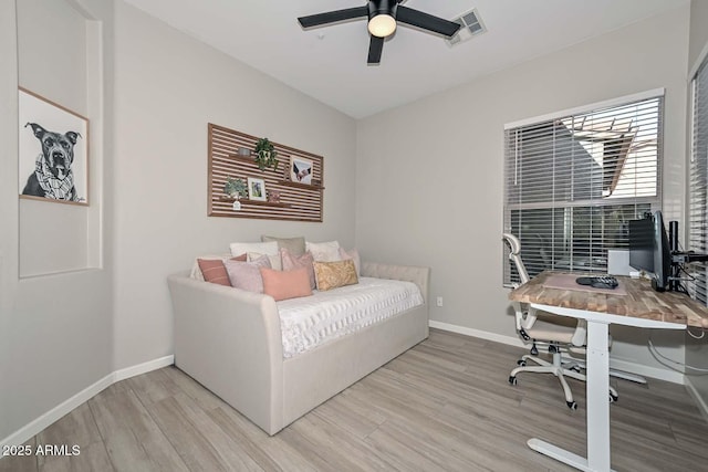 bedroom featuring light wood-style floors, baseboards, visible vents, and ceiling fan