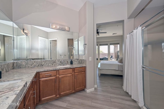 bathroom with a ceiling fan, connected bathroom, curtained shower, vanity, and wood finish floors