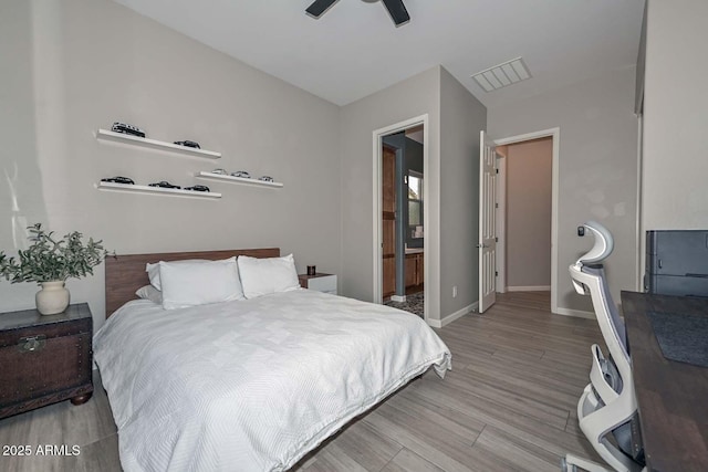 bedroom featuring light wood-type flooring, baseboards, and a ceiling fan