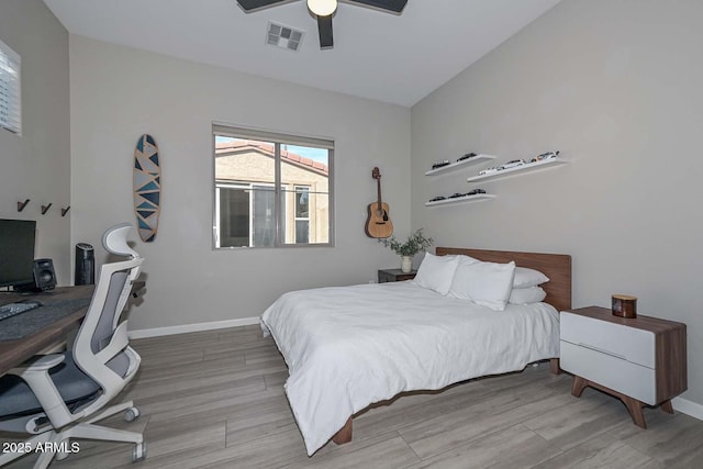 bedroom featuring light wood-type flooring, visible vents, ceiling fan, and baseboards