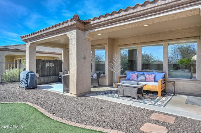 view of patio featuring fence and an outdoor living space