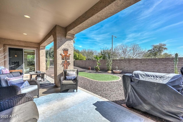 view of patio / terrace featuring a fenced backyard, a grill, and an outdoor living space