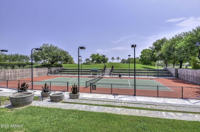 view of tennis court featuring fence