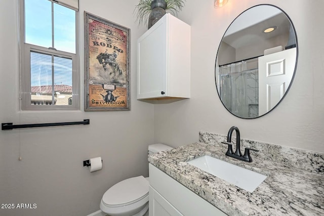 bathroom featuring a shower with curtain, vanity, and toilet