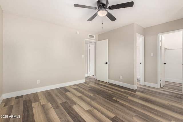 17228 N 16th Dr Unit 3, Phoenix, AZ 85023 - unfurnished bedroom with wood finished floors, ceiling fan, a closet, and a spacious closet