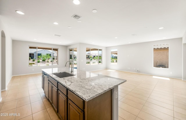 26949 W Lone Cactus Dr, Buckeye, AZ 85396 - kitchen featuring a sink, light tile patterned floors, open floor plan, a kitchen island with sink, and recessed lighting