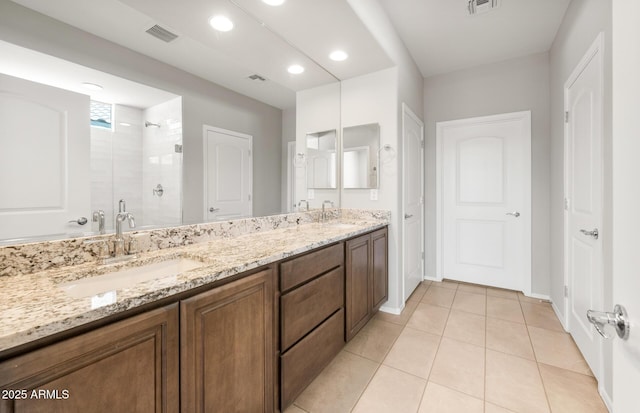 26949 W Lone Cactus Dr, Buckeye, AZ 85396 - full bathroom featuring double vanity, a stall shower, tile patterned flooring, recessed lighting, and baseboards