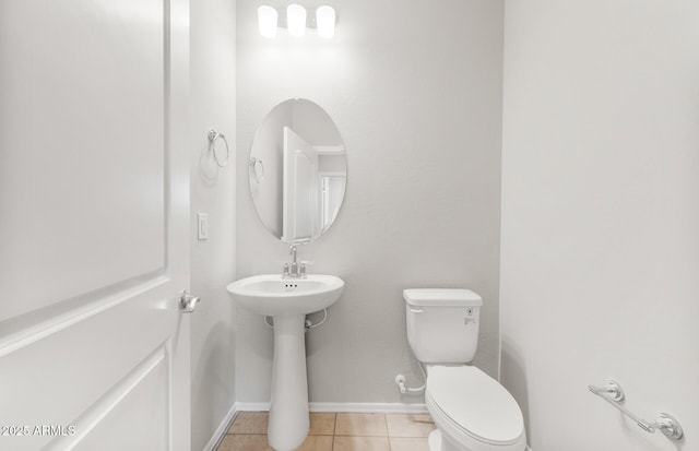 26949 W Lone Cactus Dr, Buckeye, AZ 85396 - half bathroom featuring toilet, tile patterned flooring, baseboards, and a sink