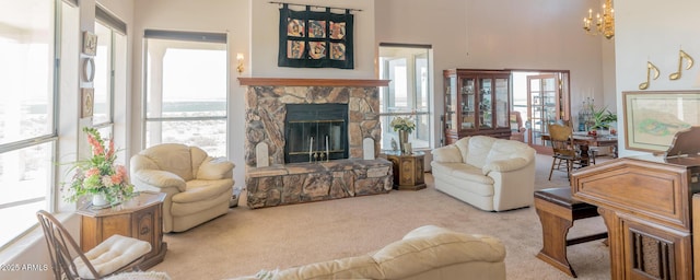 living area with a towering ceiling, plenty of natural light, a fireplace, and carpet flooring