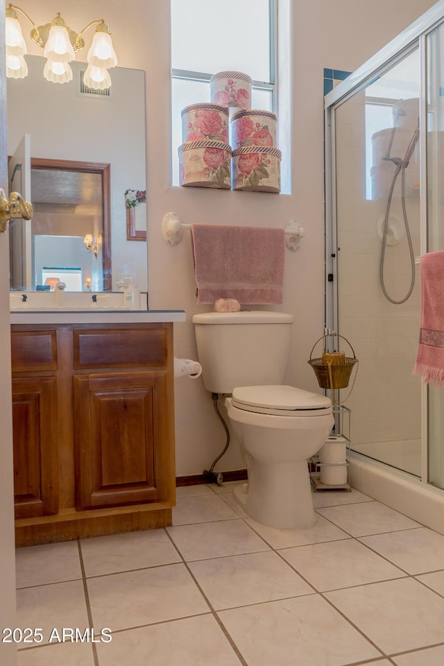 bathroom with a stall shower, tile patterned flooring, and toilet