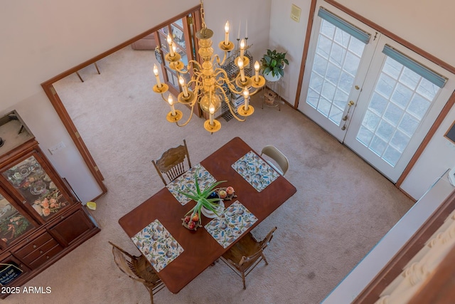 interior space with carpet floors and an inviting chandelier