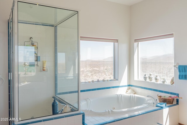 full bathroom with a stall shower, a tub with jets, and a mountain view