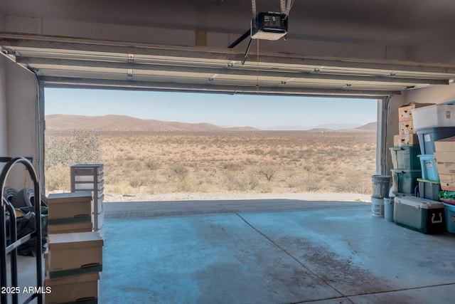 garage with a mountain view and a garage door opener