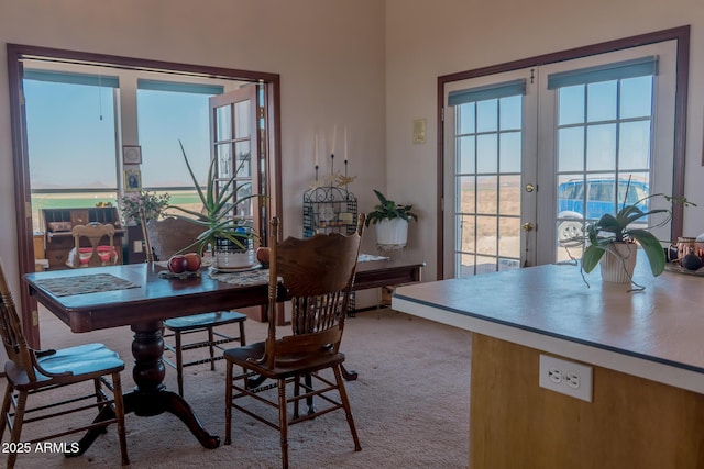 dining space featuring carpet flooring and french doors