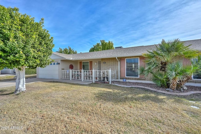 single story home with a garage and a front lawn