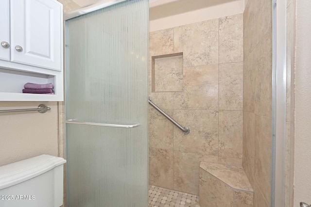 bathroom with toilet and an enclosed shower