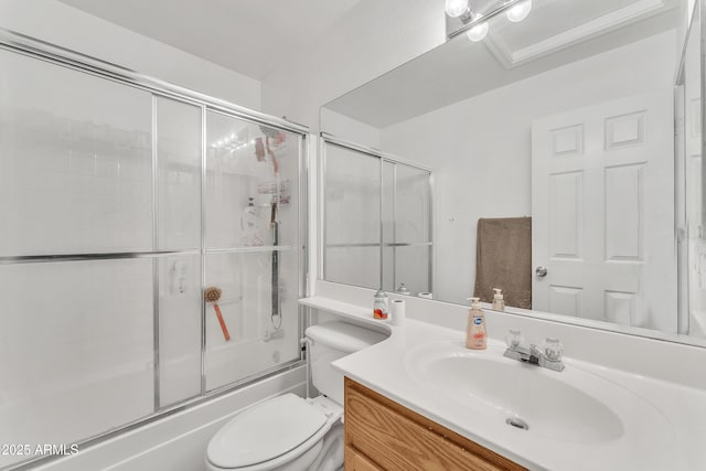 full bathroom featuring vanity, toilet, and combined bath / shower with glass door