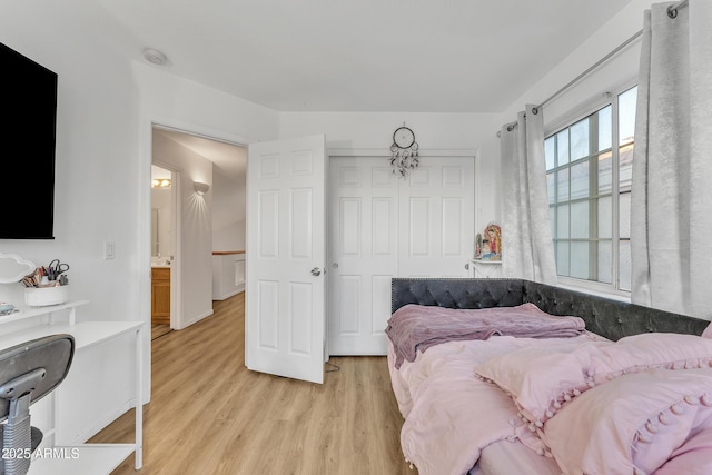 bedroom featuring a closet and light wood-type flooring