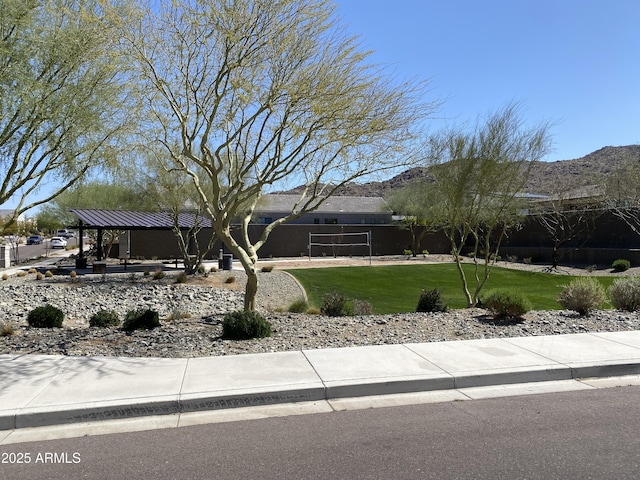 view of front facade with a mountain view and a front lawn