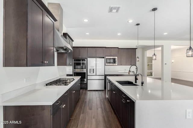 kitchen with visible vents, appliances with stainless steel finishes, dark wood-style floors, and a sink