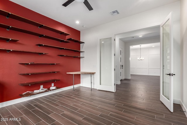 interior space with dark wood-style flooring, baseboards, visible vents, an inviting chandelier, and recessed lighting