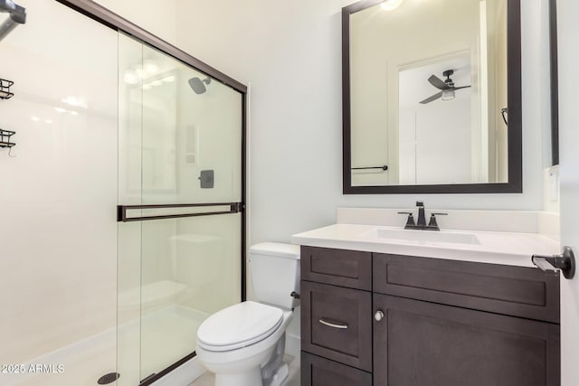 bathroom featuring a shower stall, toilet, and vanity