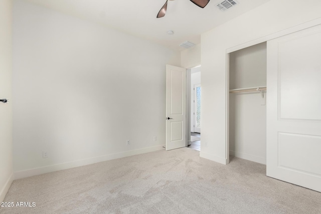 unfurnished bedroom featuring visible vents, carpet floors, a closet, baseboards, and ceiling fan