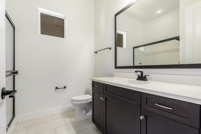 bathroom with a shower with shower door, tile patterned flooring, toilet, vanity, and baseboards