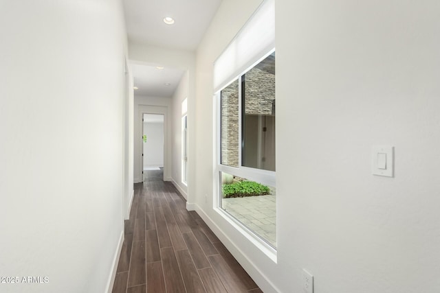 hallway featuring baseboards, recessed lighting, and dark wood-style flooring