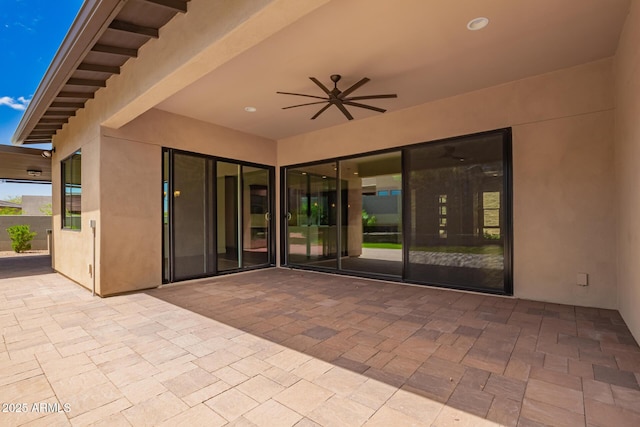 view of patio featuring ceiling fan and fence