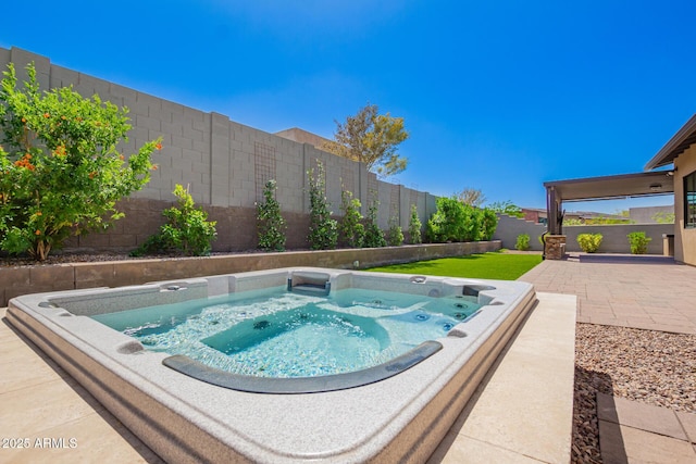view of swimming pool with a fenced backyard, hot tub deck surround, and a patio
