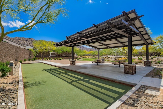 view of property's community featuring fence and a mountain view