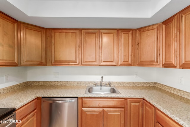 kitchen featuring brown cabinets, stainless steel appliances, and a sink