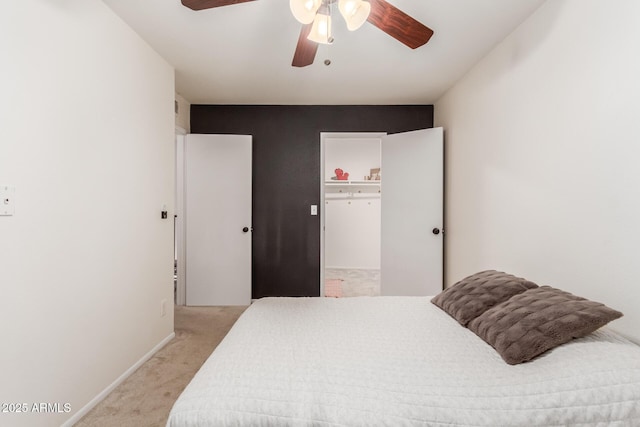 bedroom with light colored carpet, ceiling fan, and baseboards