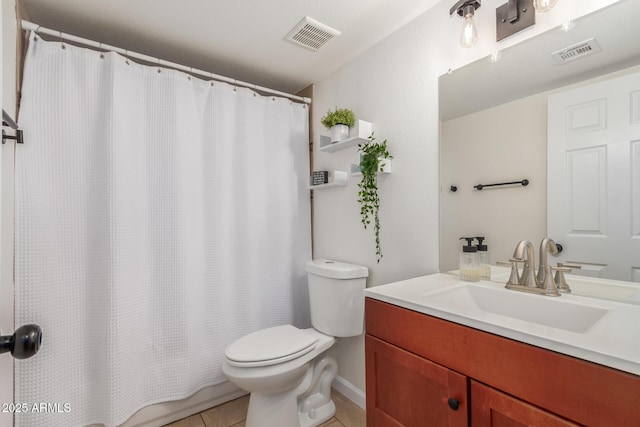 bathroom featuring toilet, vanity, visible vents, and tile patterned floors