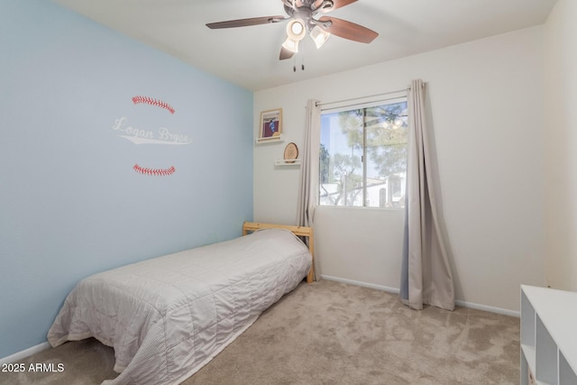 bedroom featuring a ceiling fan, light colored carpet, and baseboards