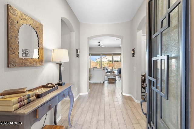 foyer entrance with ceiling fan and light hardwood / wood-style floors