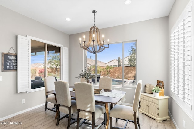 dining room featuring a wealth of natural light, a chandelier, and light hardwood / wood-style flooring