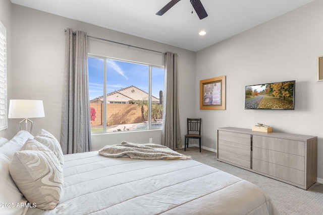 bedroom featuring light carpet and ceiling fan