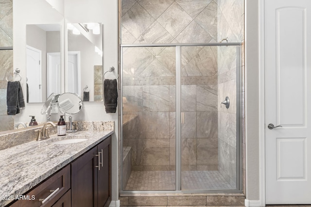 bathroom featuring vanity and a shower with shower door